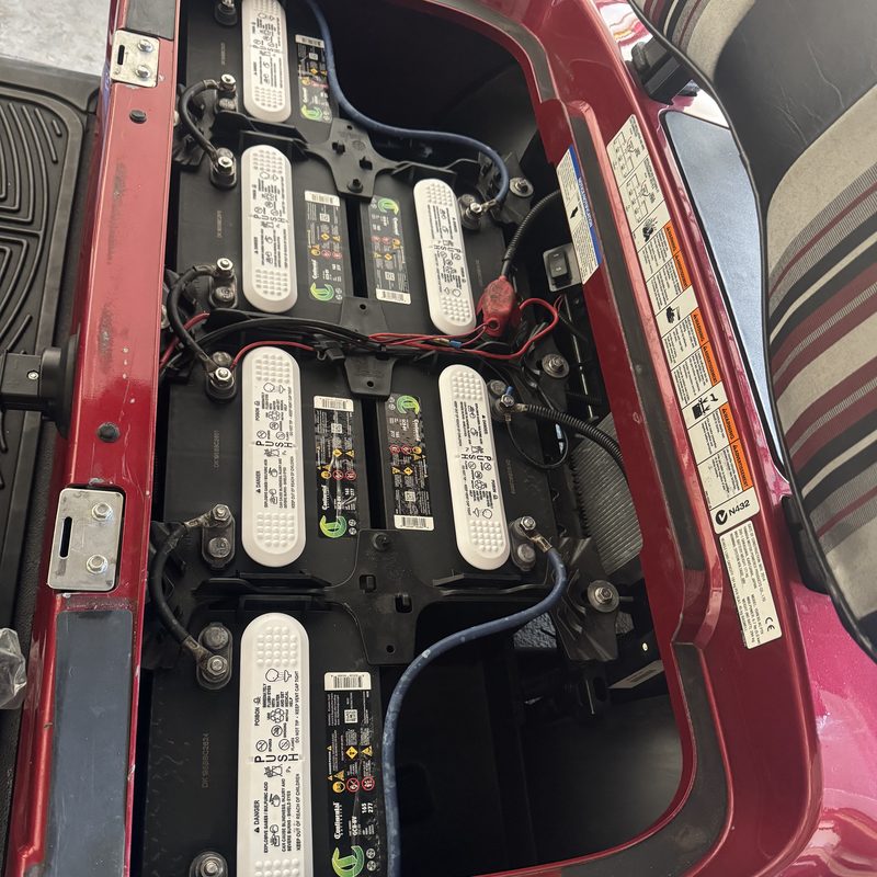 Completed on-site golf cart battery replacement on a red cart by Ocala Cart Care