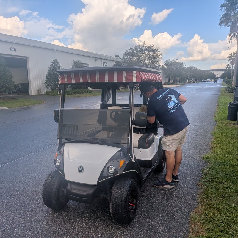 Ocala Cart Care technician servicing a white Yamaha golf cart on-site in Marion County, Florida