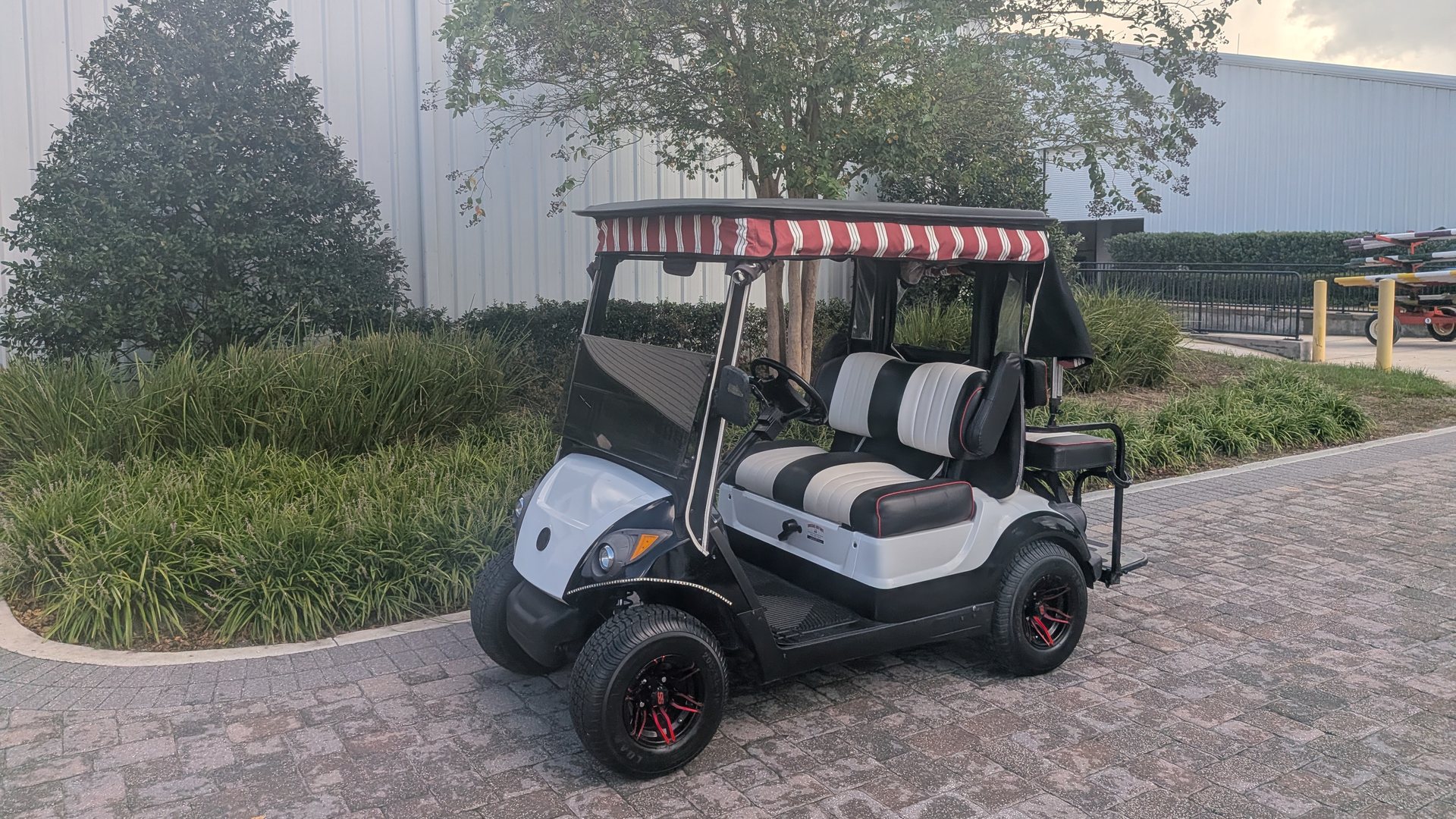 White Yamaha golf cart with custom seats detailed by Ocala Cart Care near the World Equestrian Center