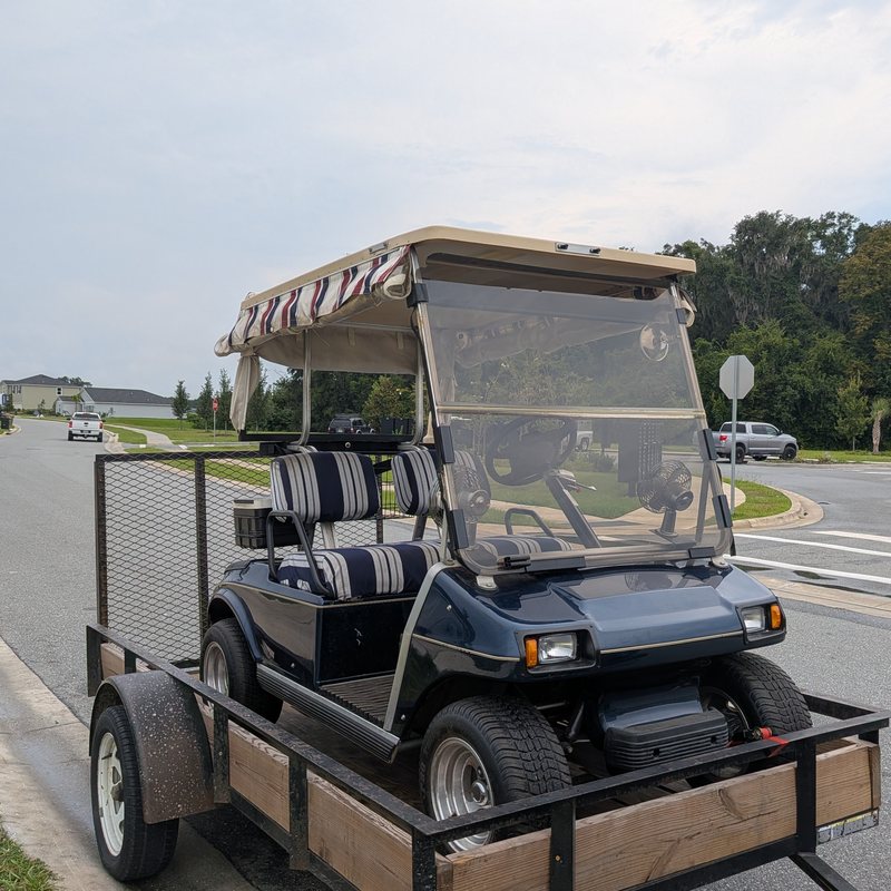 Navy blue Club Car DS golf cart ready to be transported by Ocala Cart Care